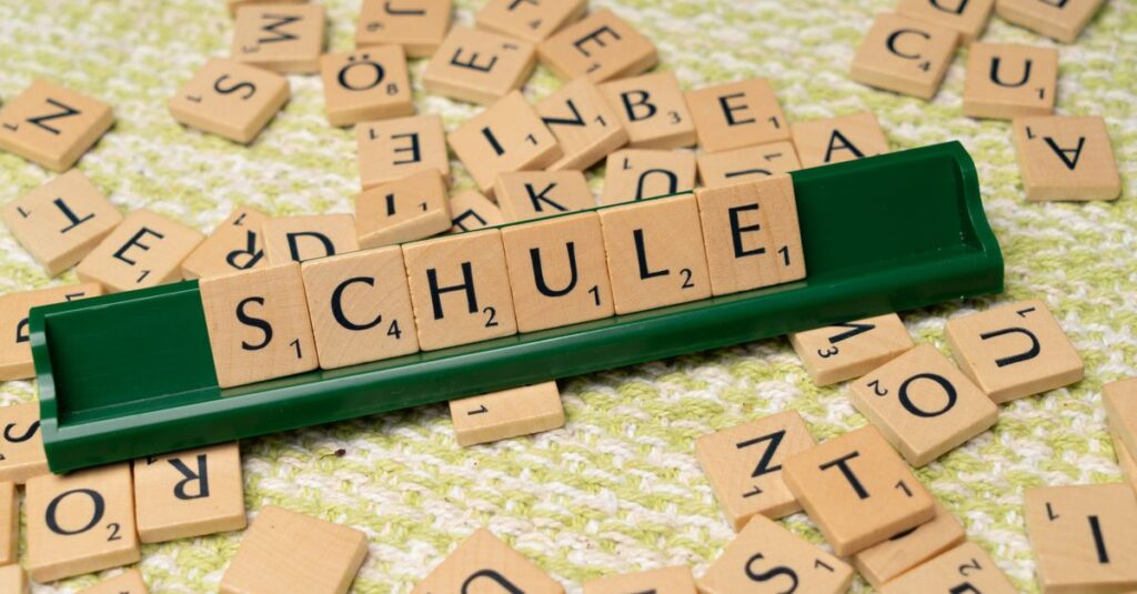 Word tiles spelling 'Schule' on table, ideal for language learning concepts.